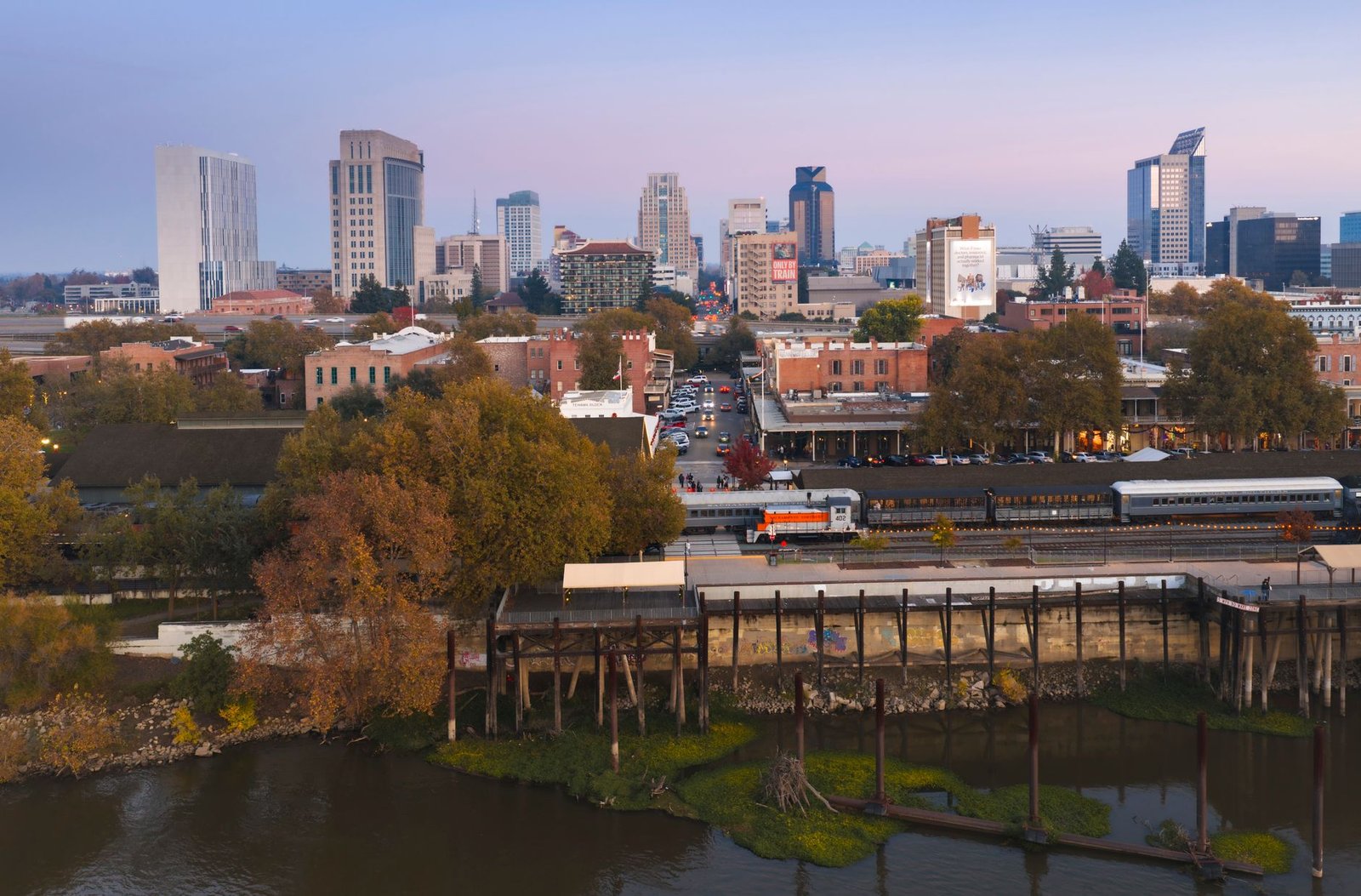 A beautiful twilight aerial view of Sacramento's urban skyline with historic Old Sacramento in foreground
