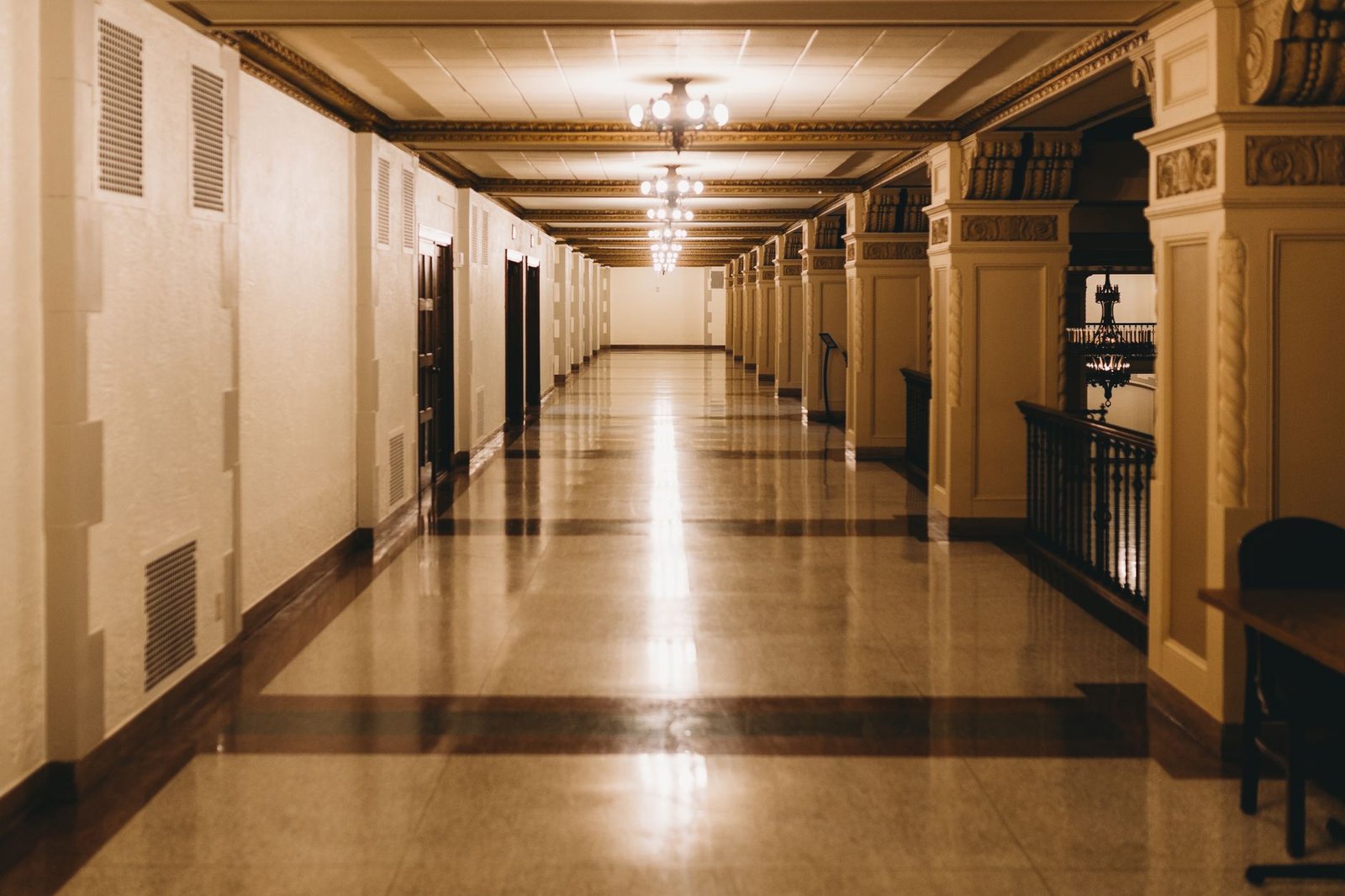 A beautifully lit, elegant hallway with intricate architectural details, adding a classic touch