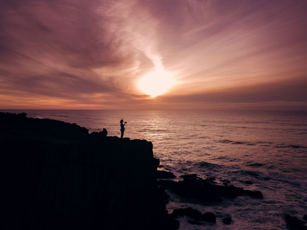 A colorful sunset over Depoe Bay, highlighting the lighthouse silhouette