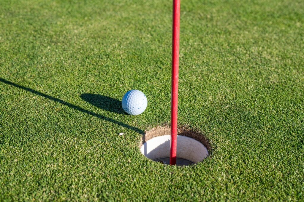 A golfer teeing off on a lush fairway in Flower Mound