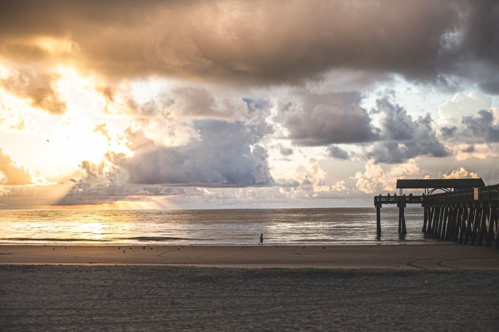 A stunning sunset with dramatic clouds over Tybee Island Pier, Savannah, Georgia
