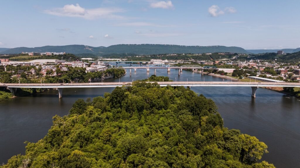 A sunny view of the Tennessee Riverwalk with people walking and biking