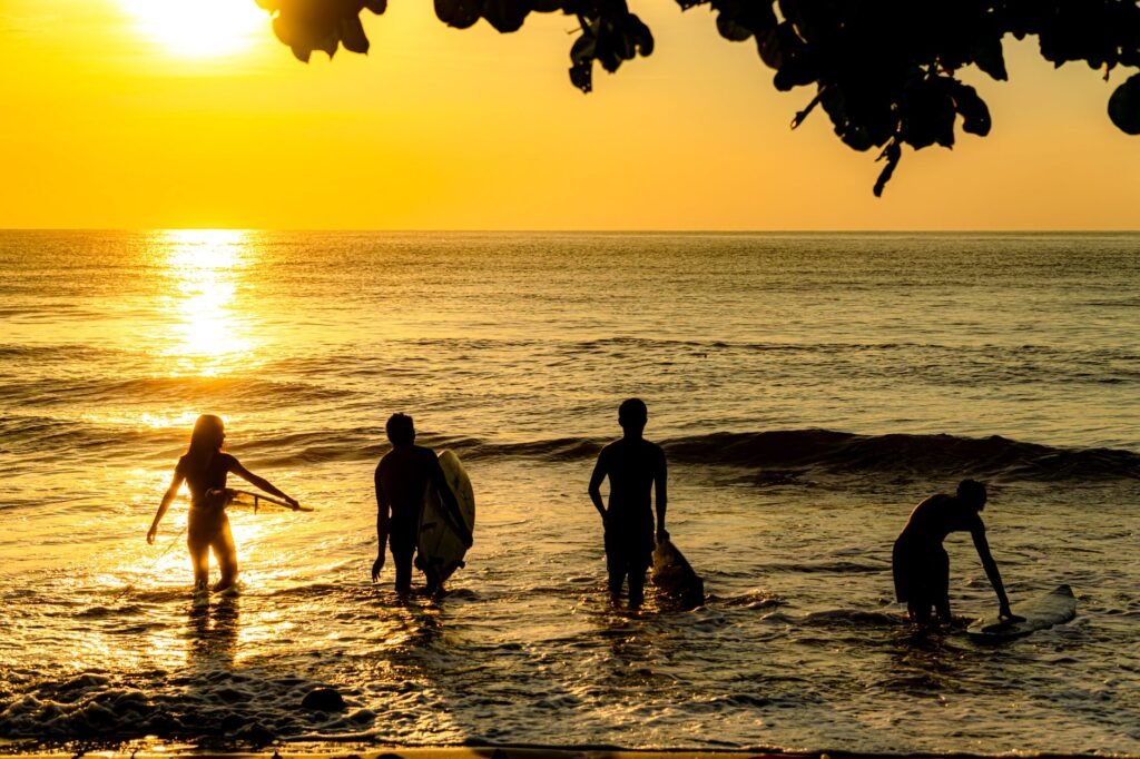 A surfer catching early light at Domes Beach, a signature Rincon experience