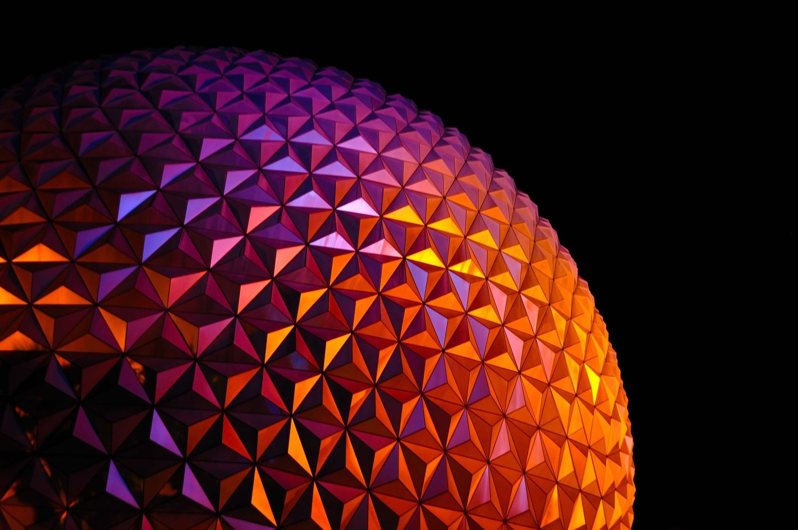 A vibrant geometric pattern dome illuminated in the dark