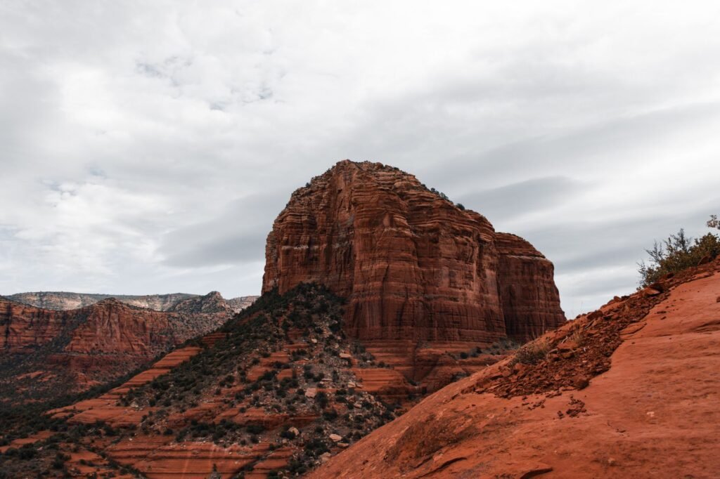 A view of a popular vortex site with swirling clouds over red rocks