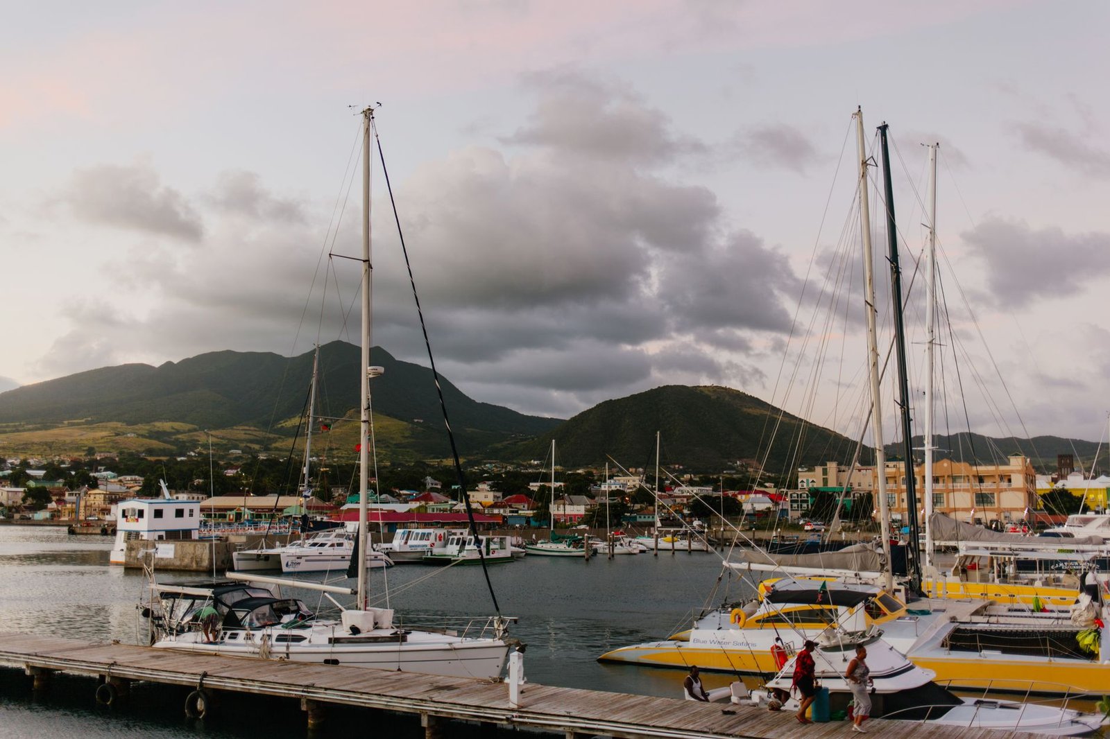 Beautiful marina with sailboats and stunning mountain backdrop at sunset