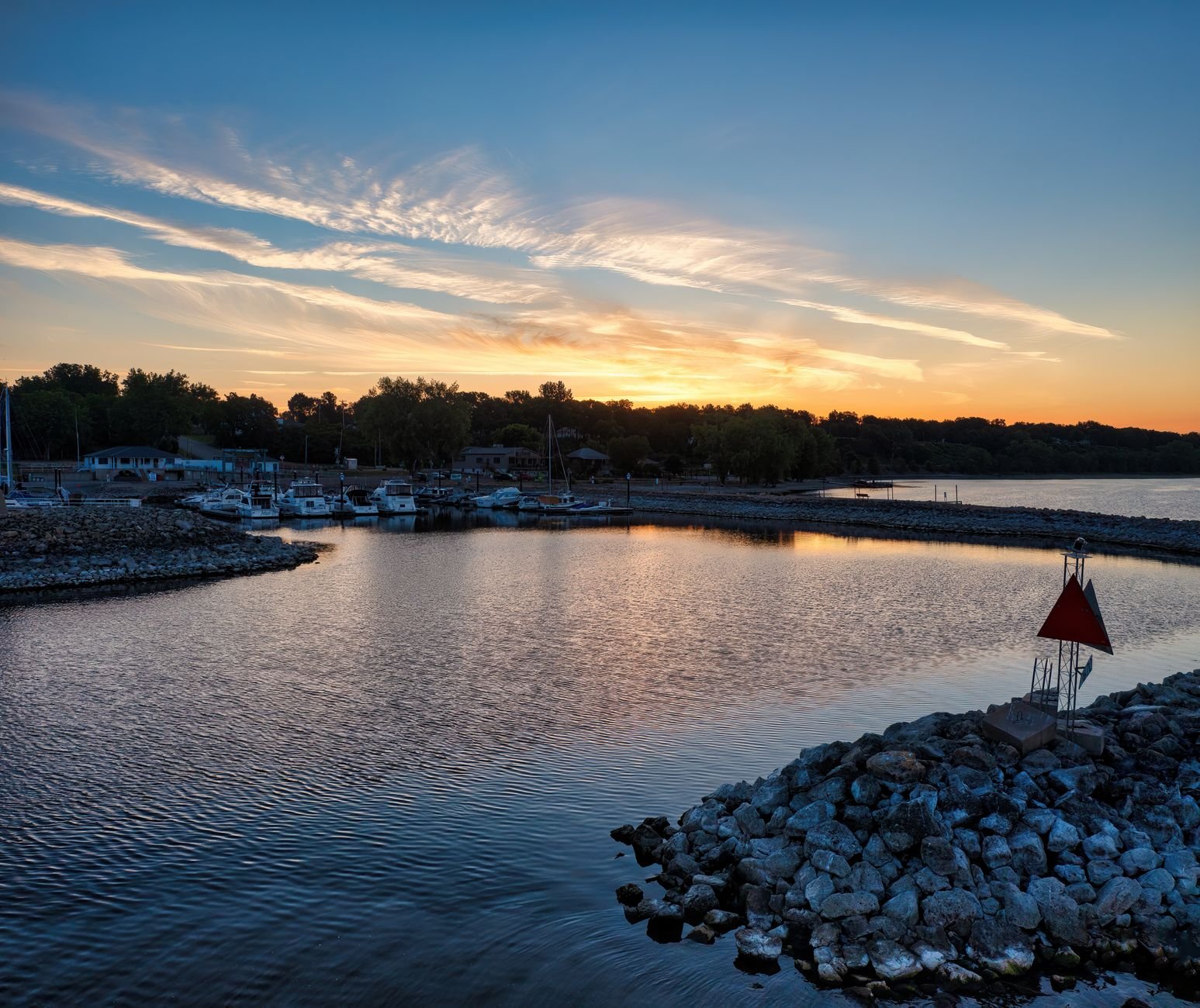 Beautiful sunset over Pepin Marina with calm waters and moored boats in Wisconsin, USA