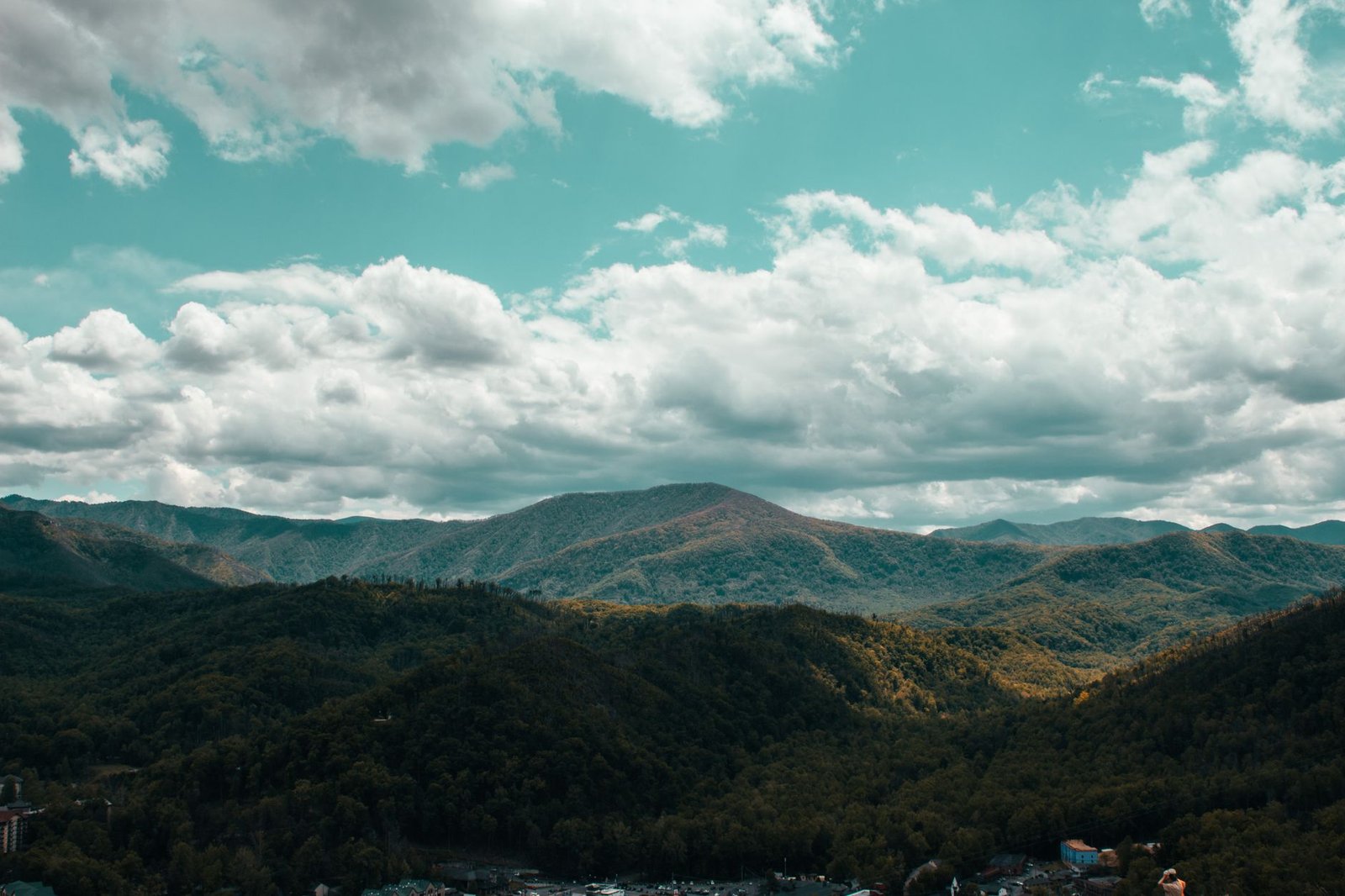 Breathtaking aerial view of the Smoky Mountains under a cloudy blue sky in Pigeon Forge