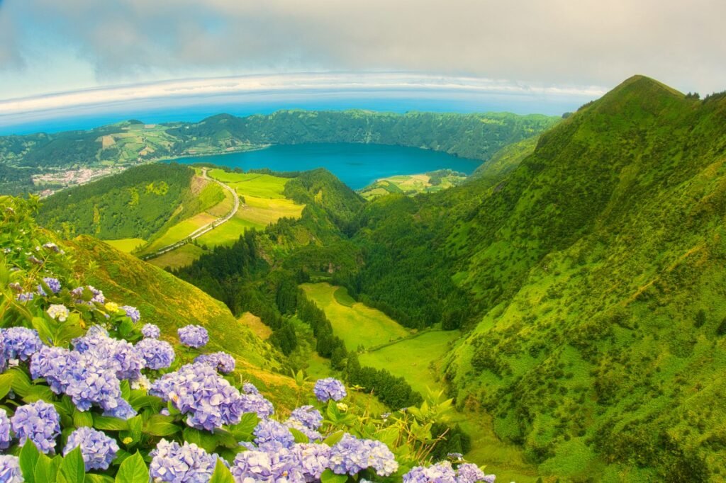 Breathtaking panoramic view of Sete Cidades in Azores with vibrant hydrangeas and lush green landscape