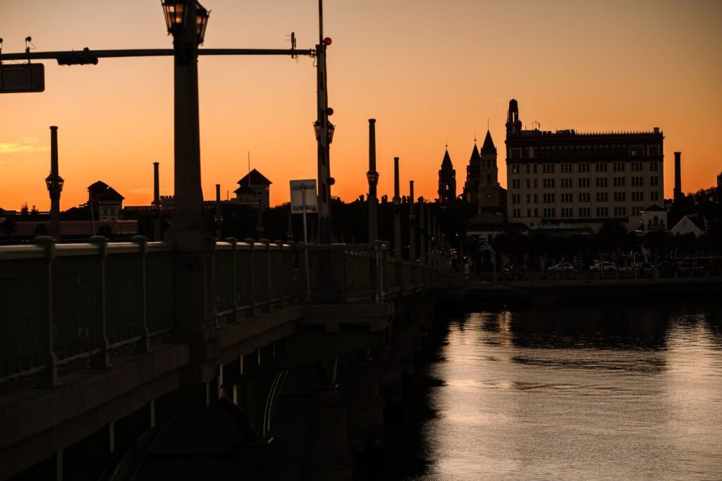 Couple strolling along the waterfront at sunset