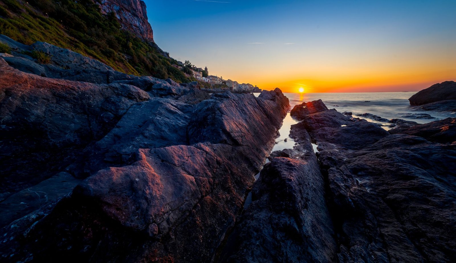Dramatic sunset over rocky coastline