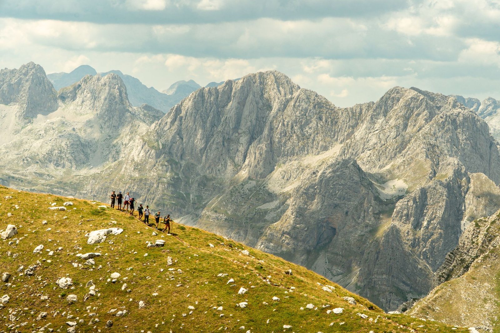 Explore the stunning landscapes of Shkodër County, Albania with a group of hikers in the picturesque mountains