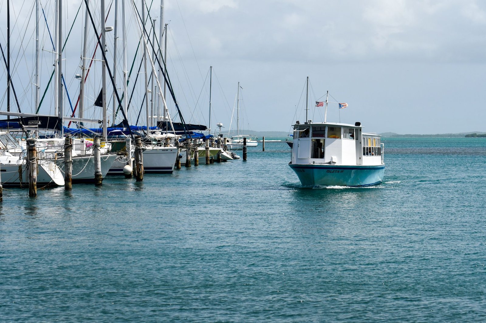Ferry boat cruising near yachts in beautiful Fajardo marina, Puerto Rico