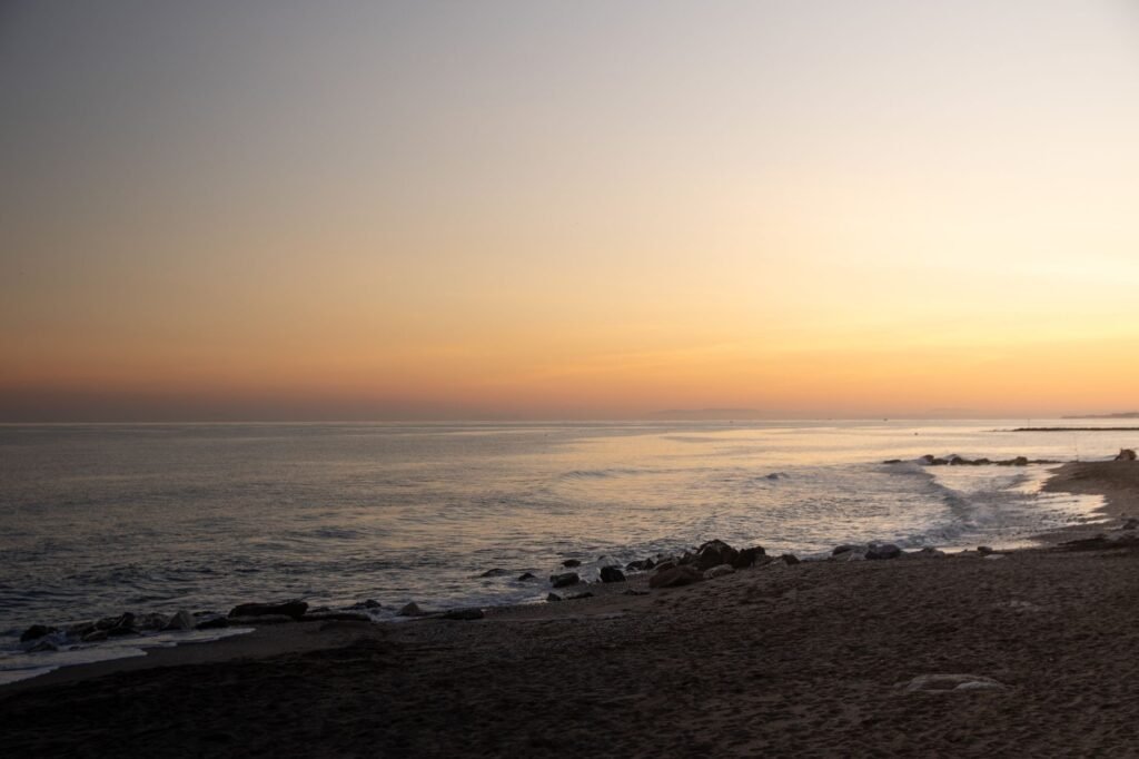 Golden sands of Catalan Bay at sunset, perfect for a relaxed evening