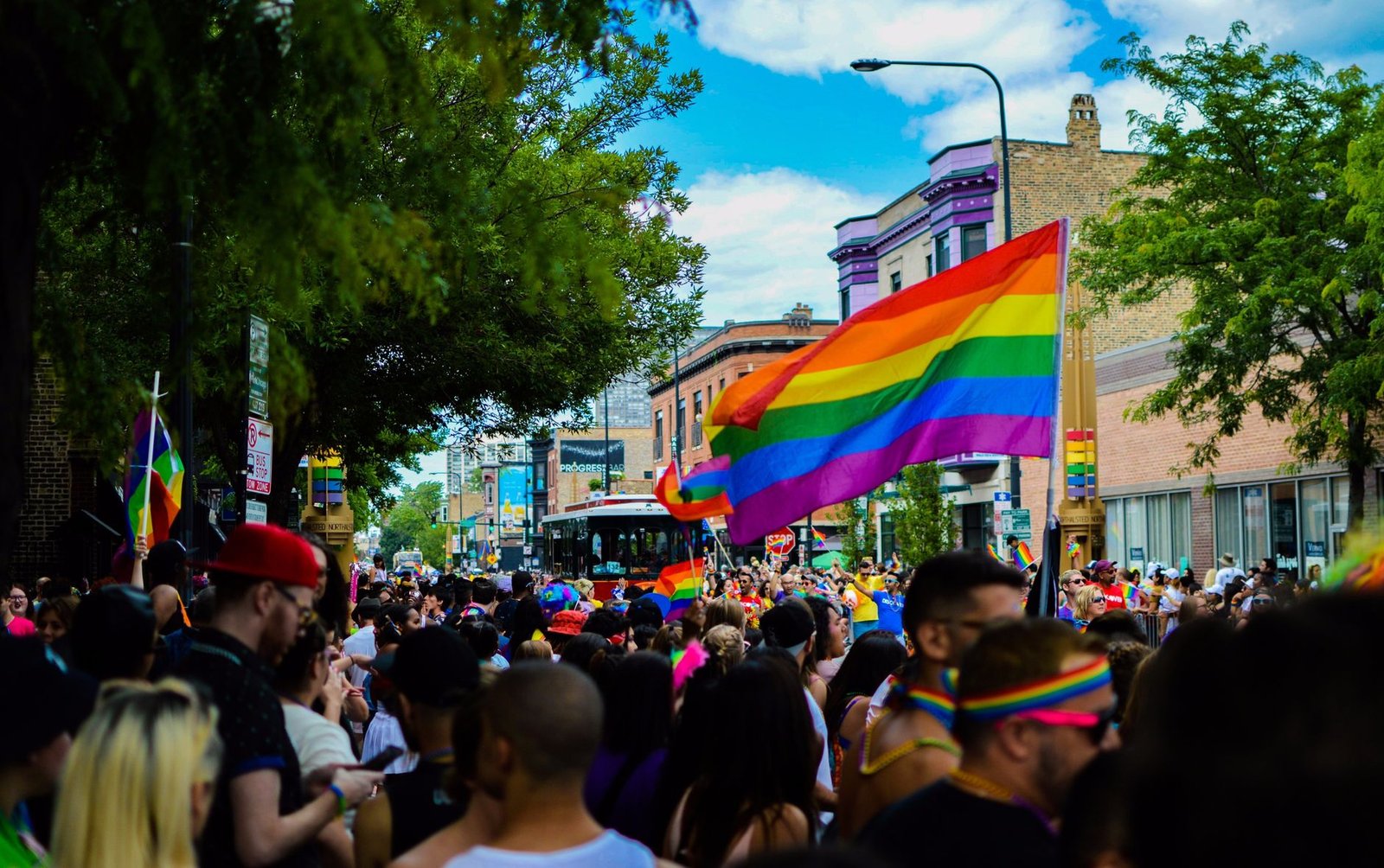 Lively Pride Parade with colorful flags and diverse crowd in Chicago