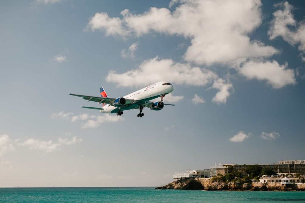 Panoramic view of Maho Beach with planes overhead