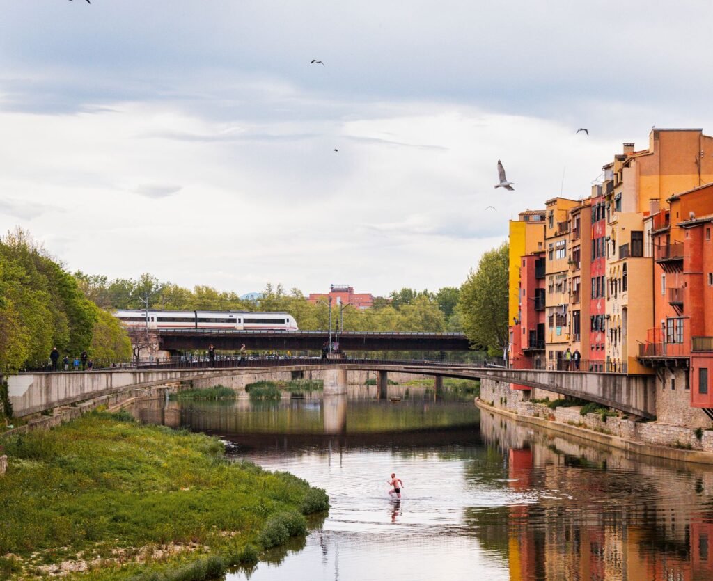 Strolling along the River Onyar showcases colorful houses and iconic bridges