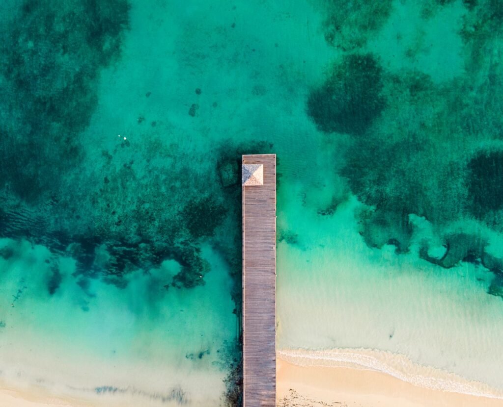 Stunning aerial view of a wooden pier extending into the turquoise waters of Ocho Rios, Jamaica