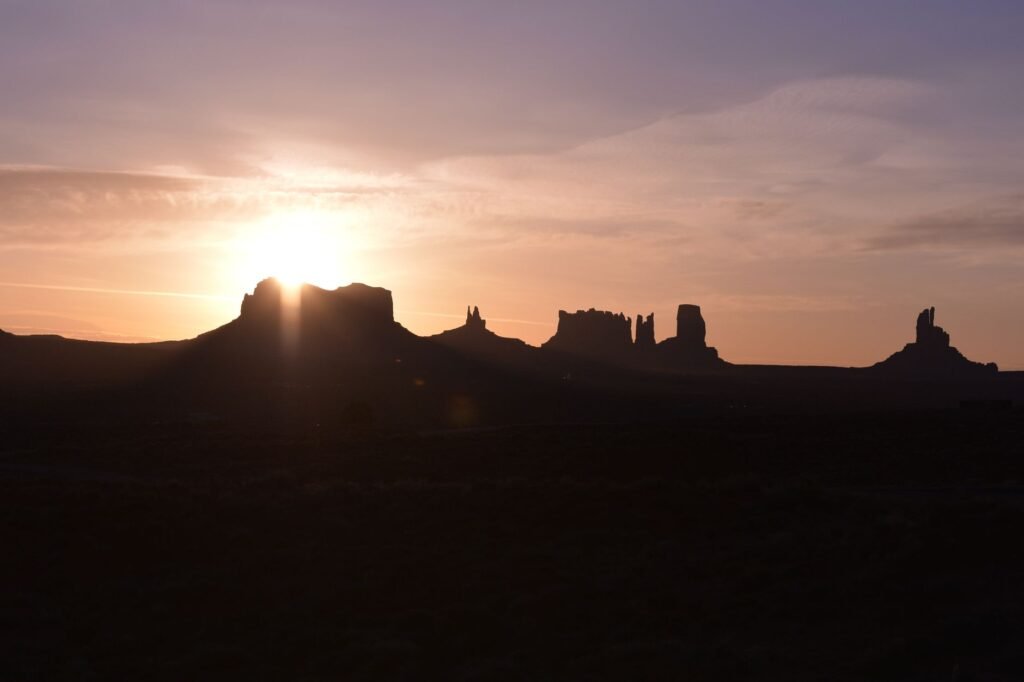 Sunrise over the iconic red sandstone mesas of Monument Valley