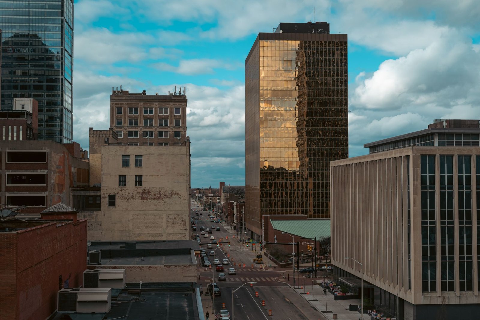 Vibrant downtown cityscape featuring modern skyscrapers and busy streets under a blue sky