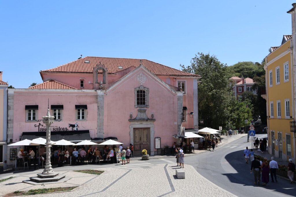 Vibrant street scene in Sintra, Portugal with colorful architecture and lively cafes